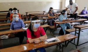 Students taking NEET exam in examination hall