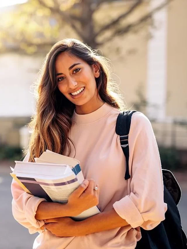 college-student-carries-books-to-her-classes