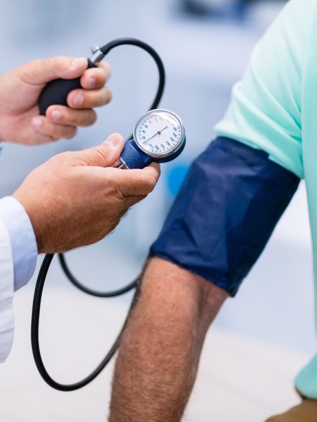 Mid section of doctor checking blood pressure of a patient